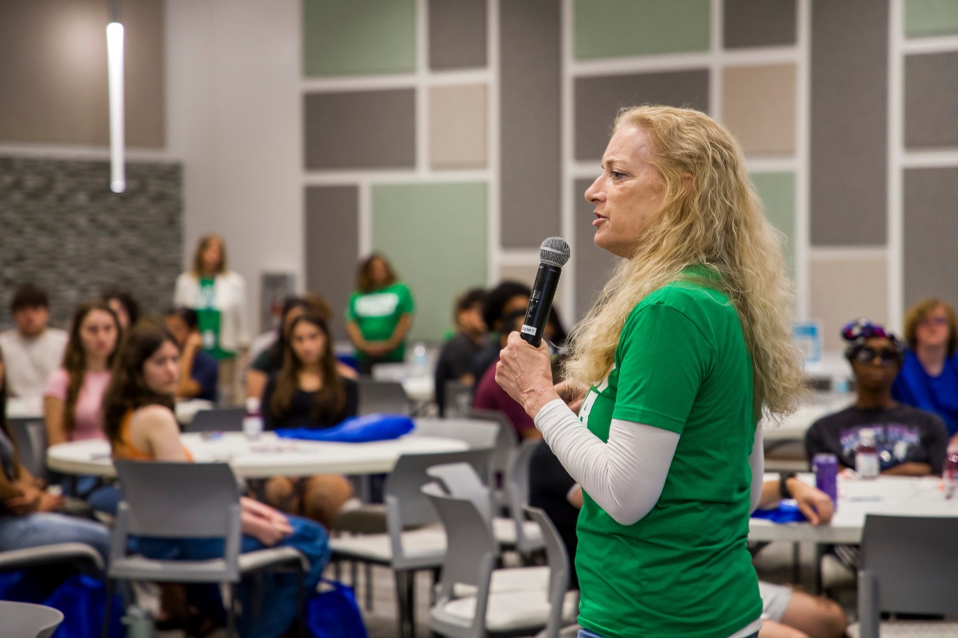 Dr. Barbara Kennedy addresses students gathered in a conference room.