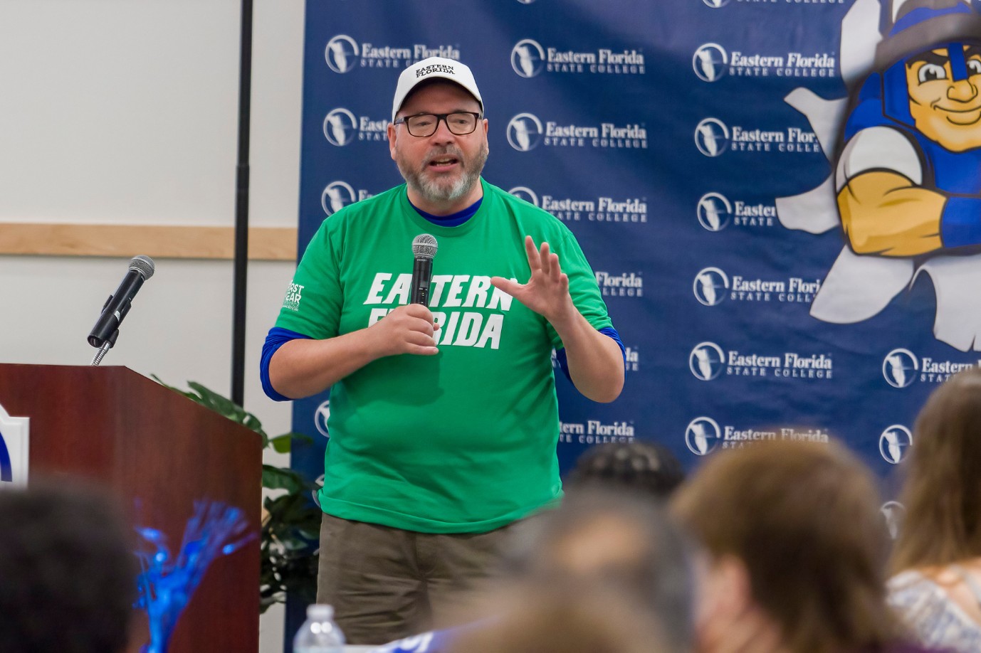 Dr. Phil Simpson addresses the students in a conference room while wearing a green EFSC shirt.